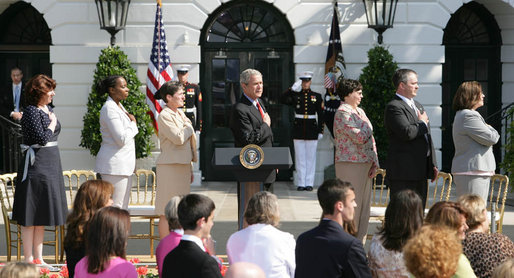 President George W. Bush stands for the national anthem with recipients of the President's Volunteer Service Award during Military Spouse Day ceremonies Tuesday, May 6, 2008, on the South Lawn of the White House. White House photo by Chris Greenberg