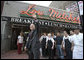 President George W. Bush waves as he leaves Lou Mitchell’s Restaurant in Chicago, Friday, July 7, 2006, following a breakfast meeting with local business leaders at the restaurant.  White House photo by Kimberlee Hewitt