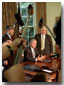 President Bush, Secretary of Energy Spencer Abraham (left) and economic advisor Larry Lindsey speak with the media in the Oval Office before the President signed an executive order that sets a standard of energy efficiency July 31, 2001. 