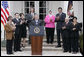 Accompanied by Iraqi citizens who voted in the recent elections, President George W. Bush delivers remarks about freedom in Iraq in the Rose Garden Tuesday, March 29, 2005. "I want to thank you for your strong belief in democracy and freedom. It's a belief that, with their vote, the Iraqi people signal to the world that they intend to claim their liberty and build a future of freedom for their country," said President Bush. "And it was a powerful signal."  White House photo by Eric Draper