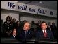 President George W. Bush answers questions from the press during a tour of the District of Columbia's Metropolitan Police Department Synchronized Operations Center, Tuesday, Nov. 12. Homeland Security Advisor Tom Ridge, right, also participated in the tour.   White House photo by Paul Morse