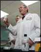 President George W. Bush holds a jar of spruce wood chips during a tour of the labs at Novozymes North America, Inc., Thursday, Feb. 22, 2007 in Franklinton, N.C., during a demonstration on how cellulosic ethanol can be produced from bio mass materials. White House photo by Paul Morse