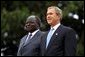 Presidents Bush and Kibaki watch the military review portion of the State Arrival Ceremonies on the South Lawn of the White House Monday, October 5, 2003.  White House photo by Susan Sterner