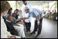 President George W. Bush greets a young child on his arrival Monday, Feb. 18, 2008, for a tour of the outpatient clinic of the Meru District Hospital in Arusha, Tanzania. White House photo by Eric Draper