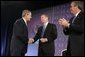 President George W. Bush is congratulated by Attorney General John Ashcroft and Florida Governor Jeb Bush after making remarks at the National Training Conference on Combating Human Trafficking in Tampa, Florida on Friday July 16, 2004.  White House photo by Paul Morse