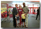 After talking with several families about how far $600 can go during family shopping trips, President Bush poses for pictures with one of the families just outside the Target Snack Bar at a retail location in Kansas City, Mo., Aug. 21, 2001. White House photo by Moreen Ishikawa.