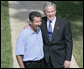 President George W. Bush smiles as he stands with Rockey Vaccarella during a statement to the media Wednesday, Aug. 23, 2006, on the White House lawn. Vaccarella, who lost his home in the wake of Hurricane Katrina and who drove to Washington D.C. to speak directly to the President, told reporters, "I just don't want the government and President Bush to forget about us," adding, "If we had this President for another four years, I think we'd be great." White House photo by Kimberlee Hewitt