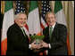 President George W. Bush is presented with a bowl of shamrocks by Ireland's Prime Minister Bertie Ahern at a ceremony in the Roosevelt Room at the White House, March 16, 2007. White House photo by Joyce N. Boghosian