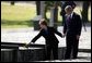 President George W. Bush and Mrs. Bush�place a rose at the end of the railroad tracks�at the Birkenau concentration camp in Poland, Saturday, May 31, 2003.  White House photo by Paul Morse