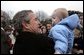 Welcomed by an enthusiastic crowd, President George W. Bush holds a child during an airport arrival greeting at RAF Aldergrove airport in Northern Ireland, Monday, April 7, 2003.  White House photo by Eric Draper