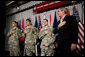 President George W. Bush recites the Pledge of Allegiance Monday, July 24, 2006, at Walter Reed Army Medical Center in Washington, D.C., joining newly sworn-in American citizens, Specialist Sergio Lopez, 24, of Bolingbrook, Ill., left, Specialist Noe Santos-Dilone of Brooklyn, N.Y., center, and Private First Class Eduardo Leal-Cardenas of Los Angeles, Calif., during their naturalization ceremony. White House photo by Eric Draper