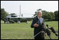 President George W. Bush addresses reporters on the South Lawn of the White House Sunday, July 30, 2006, saying America will work together with members of the United Nations Security Council to develop a solution that will bring a sustainable peace to the conflict in Lebanon. White House photo by Paul Morse