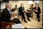 President George W. Bush talks with State Secretary Colin Powell and FEMA Director Mike Brown, far right, during an Oval Office briefing on the tsumami relief efforts Monday, Jan. 10, 2005.   White House photo by Eric Draper