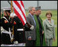 President George W. Bush and Mrs. Laura Bush stand with President Hamid Karzai of Afghanistan during an arrival ceremony at Camp David, Sunday, August 5, 2007. White House photo by Eric Draper