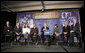 President George W. Bush answers a question from the audience at a forum on health care initiatives Wednesday, Feb. 21, 2007, at the Chattanooga Convention Center in Chattanooga, Tenn. President Bush is joined by panelist, from left to right, U.S. Sec. of Health and Human Services Michael O. Leavitt, Dr. Joseph Cofer, Martha Ginn, Will Smith, Amy Childers, Danny Jennings and Governor Phil Bredesen. White House photo by Paul Morse