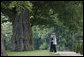 President George W. Bush walks with Germany's Chancellor Angela Merkel on the grounds of the Schloss Meseberg Wednesday, June 11, 2008, during the President's visit to Europe. The two spent the day in meetings and held a joint press availability before the President continued on to Rome. White House photo by Eric Draper