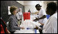 Mrs. Laura Bush hands out meals to evacuees Friday, Oct. 3, 2008, during her visit to the Auchan Red Cross Shelter in Houston for those individiuals and families who still need assistance as a result of Hurricane Ike. White House photo by Chris Greenberg