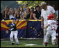 John Cloer, age 7, from Sierra Madre, Calif., makes the catch as West Virginia's Brody Kehrer, age 5, races to beat him to the base during All-Star tee ball action on the White House South Lawn on July 16, 2008. One child represented each state and the District of Columbia and teams were divided into four regions with California, represented on the Western team and West Virginia in the Southern team. White House photo by Eric Draper