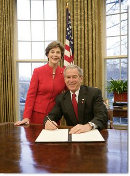 President George W. Bush is joined by Mrs. Laura Bush in the Oval Office at the White House, Thursday, Feb. 1, 2007, as President Bush prepares to sign the Presidential Proclamation in honor of American Heart Month. American Heart Month encourages Americans to take actions that reduce their risk and increase awareness of heart disease.  White House photo by Eric Draper