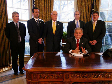President George W. Bush speaks to the press after the signing of the 2008 Economic Report Monday Feb. 11, 2008, in the Oval Office. Joining President Bush are, from left, Chuck Blahous, Deputy Assistant to the President for Economic Policy; Pierce Scranton, Chief of Staff, Council of Economic Advisers; Eddie Lazear, Chairman, Council of Economic Advisers; Donald Marron, Senior Economic Adviser, Council of Economic Advisers; and Keith Hennessey, Assistant to the President for Economic Policy. White House photo by Joyce N. Boghosian