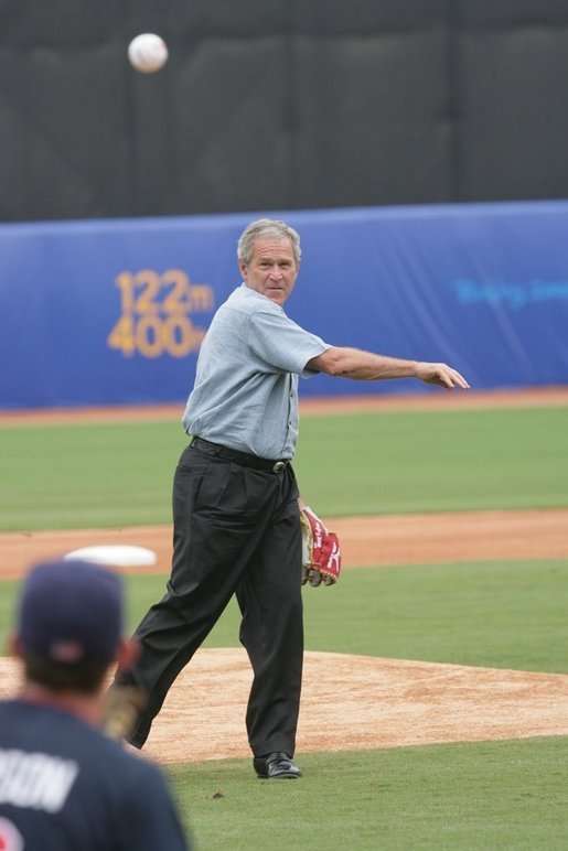 President George W. Bush throws out the first pitch to the U.S. Olympic men's baseball team catcher Lou Marson before a practice game against the Chinese Olympic men's baseball team Monday, Aug. 11, 2008, at the 2008 Summer Olympic Games in Beijing. White House photo by Chris Greenberg