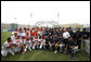 President George W. Bush poses for photos with members of the U.S. and China's men's Olympic baseball teams prior to a practice game between the two teams Monday, Aug. 11, 2008, at the 2008 Summer Olympic Games in Beijing. White House photo by Eric Draper