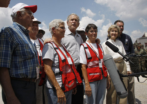 President George W. Bush stands with a group of Red Cross volunteers as he talks with reporters Monday, Sept. 1, 2008 at the Alamo Regional Command Reception Center at Lackland Air Force Base in San Antonio, Texas, where the President participated in a briefing on the response preparation for Hurricane Gustav. Texas Senator Kay Bailey Hutchison and FEMA Administrator David Paulison are seen at right. White House photo by Eric Draper