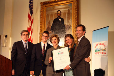 Mrs. Laura Bush presents the Fifth Annual Preserve America History Teacher of the Year award to David Mitchell, right, Friday, Oct. 24, 2008, at the Union League Club in New York City. She is joined by Dr. James Basker, President, Gilder Lehrman Institute of American History, left, and David Mitchell's students from Masconomet Regional High School in Boxford, Mass., David Burbank, 17, and Molly Byman, 18. The award notes the importance of teaching history and highlights the Preserve America initiative. White House photo by Chris Greenberg
