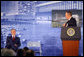 President George W. Bush smiles during an introduction by his father, former President George H.W. Bush Friday, Aug. 8, 2008, during the dedication of the United States Embassy in Beijing. White House photo by Eric Draper