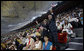 President George W. Bush waves an American flag as he and Mrs. Laura Bush stand and cheer during the entrance of the U.S. athletes into China's National Stadium Friday, Aug. 8, 2008, in Beijing. White House photo by Eric Draper