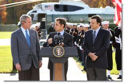 President George W. Bush listens as French President Nicolas Sarkozy, center, adresses the media during a meeting at Camp David to discuss the economic crisis and the need for coordinated global response, Saturday, October 18, 2008. The two presidents are joined by Jose Manuel Barroso, President of the European Commission, at right.  White House photo by Chris Greenberg