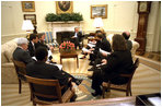 One day after announcing his plan, President George W. Bush discusses the AIDS policy with advisors in the Oval Office Jan. 29, 2003. "We believe in the value and dignity of every human life," said the President during the bill's May 27th signing ceremony. "In the face of preventable death and suffering, we have a moral duty to act, and we are acting."