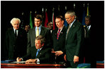 President Bush signs H.R. 1298, The U.S. Leadership Against HIV/AIDS Tuberculosis and Malaria Act of 2003, at the U.S. State Department May 27, 2003. Standing with the President are, from left, Representative Tom Lantos, D-Calif., Senator Bill Frist (R-Tenn., Secretary of Health and Human Services Tommy Thompson and Secretary of State Colin Powell.