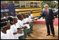 President George W. Bush is greeted by school children Thursday, Feb. 21, 2008, on his arrival to the University of Liberia to attend a education roundtable in Monrovia, Liberia. White House photo by Eric Draper