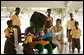 Mrs. Laura Bush participates in a reading lesson with students in their "reading hut" with the school's reading mascot Wednesday, Feb. 20, 2008, at the Mallam D/A Primary School in Accra, Ghana. White House photo by Shealah Craighead