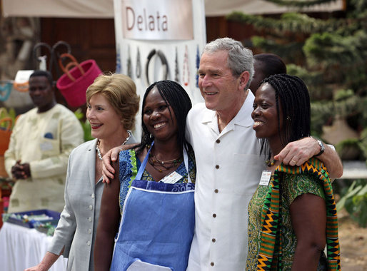 President George W. Bush and Mrs. Laura Bush pose for a photo with two women Wednesday, Feb. 20, 2008, during his visit to the International Trade Fair Center in Accra, Ghana. White House photo by Eric Draper