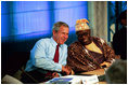 President George W. Bush talks with President Olusegun Obasanjo of Nigeria during a G8 Summit working session in Evian, France, June 1, 2003. The G8 leaders and the leaders of the New Partnership for Africa's Development (NEPAD) highlighted greater cooperation between the G8 and NEPAD and discussed challenges and opportunities going forward. President Bush and President Obasanjo are working together to forge an African Action Plan that removes obstacles of trade barriers, illiteracy, infectious disease, unsustainable debt and hunger. President Bush and President Obasanjo agreed that such a partnership must be based on mutual respect and responsibility. 