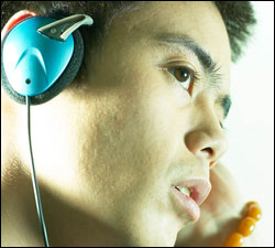 Photo: A man listening to a podcast.