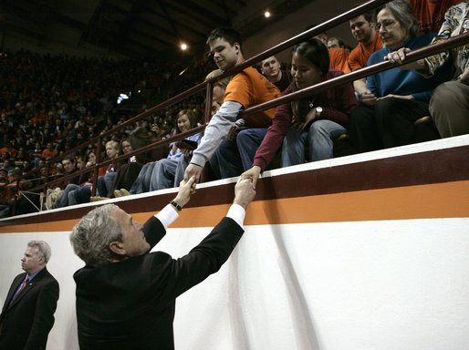 President George W. Bush reaches up to students at Virginia Tech while attending a Convocation Tuesday, April 17, 2007, honoring those involved with Monday's shootings. Thirty-three people, including the gunman, were killed during the country's deadliest shooting that occurred on the campus of the Blacksburg, Va. campus. White House photo by Eric Draper