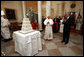 President George W. Bush and Mrs. Laura Bush lead the celebration of the 81st birthday of Pope Benedict XVI as he's presented a cake by White House Pastry Chef Bill Yosses Wednesday, April 16, 2008, at the White House. White House photo by Eric Draper