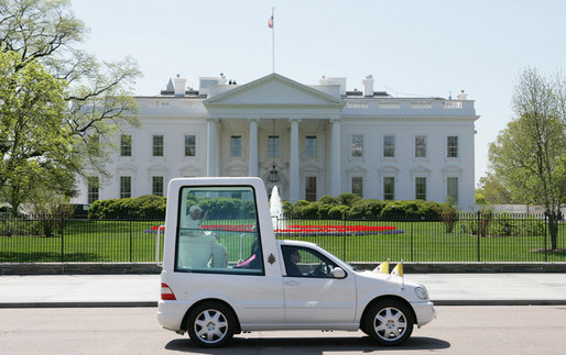 Pope Benedict XVI waves from the Pope-mobile as he passes the White House on Pennsylvania Avenue Wednesday, April 16, 2008, following a welcoming ceremony in his honor on the South Lawn. White House photo by Chris Greenberg