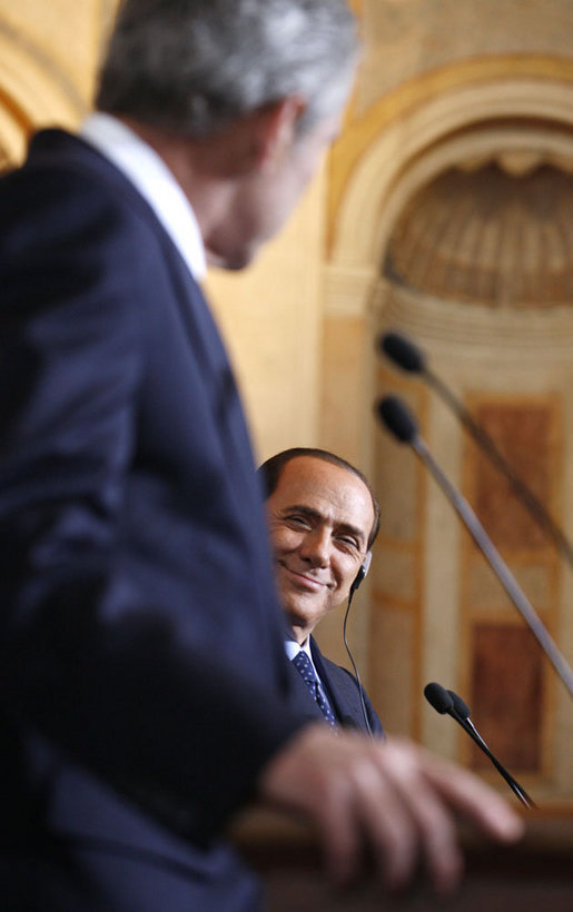 A smiling Italian Prime Minister Silvio Berlusconi listens as President George W. Bush addresses reporters at their joint press availability Thursday, June 12, 2008, at the Villa Madama in Rome. White House photo by Eric Draper