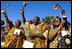 Guests in traditional Ghanaian dress celebrate the arrival of President John Agyekum Kufuor of Ghana to the White House Monday, Sept. 15, 2008, during a South Lawn Arrival Ceremony.