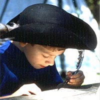 Boy practices 18th-century writing at FestiFall