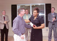 HBA President Ed Jackson, presents Bobbie Jo Furlow with the keys as Mayor George Dement (left) and Habitat executives Pat Joyner and Clair White look on.