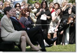 The cameras are turned to President George W. Bush as he sits with Ellen Patton, left, and Colleen Saffron, two of the six recipients of the President's Volunteer Service Award, during Military Spouse Day ceremonies Tuesday, May 6, 2008, on the South Lawn of the White House.  White House photo by Joyce N. Boghosian
