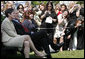 The cameras are turned to President George W. Bush as he sits with Ellen Patton, left, and Colleen Saffron, two of the six recipients of the President's Volunteer Service Award, during Military Spouse Day ceremonies Tuesday, May 6, 2008, on the South Lawn of the White House. White House photo by Joyce N. Boghosian