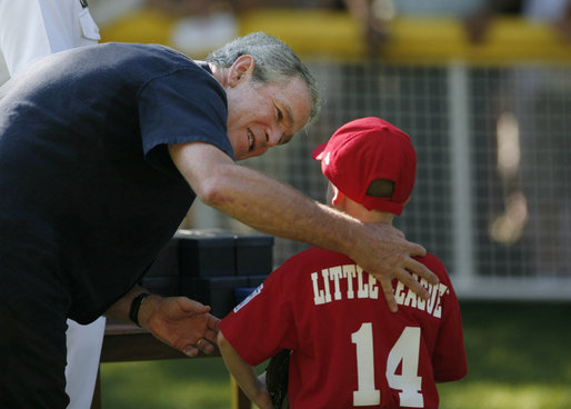 President George W. Bush presents a game ball to Stripes player Adam Plante, 6, of Burke, Va., folllowing the Tee Ball on the Sotuh Lawn: A Salute to the Troops game Sunday, Sept. 7, 2008, played by the children of active-duty military personnel. White House photo by Andrew Hreha