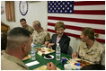 Laura Bush laughs with troops as they eat dinner in the Dragon Chow Dining Hall at Bagram Air Base in Kabul, Afghanistan, Wednesday, March 30, 2005. 