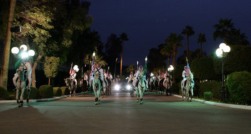 Escorted by a ceremonial horse procession, the limousine carrying President George W. Bush arrives at the Guest Palace Monday, Jan. 14, 2008, in Riyadh, Saudi Arabia. White House photo by Chris Greenberg